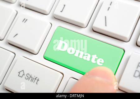 Pressing donate key on keyboard Stock Photo