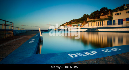 Shoalstone outdoor saltwater swimming pool at Brixham in South Devon during an early evening sunset. Stock Photo