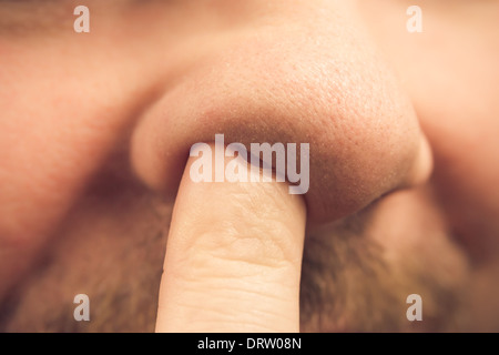 Closeup of a finger in the nose Stock Photo