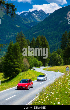 Alfa Romeo and Porsche 911 on touring holidays in the Swiss Alps, Swiss National Park, Switzerland Stock Photo