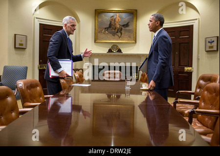 US President Barack Obama talks with Chief of Staff Denis McDonough after meeting with senior advisors in the Roosevelt Room of the White House August 5, 2013 in Washington, DC. Stock Photo