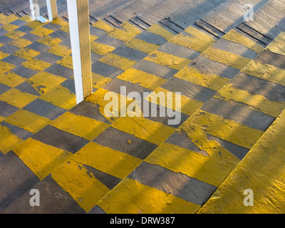 Yellow safety stripes on the concrete steps of the grandstand at Worcester's racecourse. Stock Photo