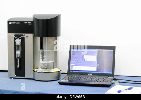 Integrated syringe liquid sampler and optical particle counting system with software interface. Stock Photo