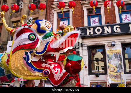 Chinese costume zodiac animals. Traditional golden New Year dragon dance festival in Chinatown, Manchester, UK.  2nd February, 2104. High pole lion dance at the  Chinese New Year in Albert Square, Manchester the North's biggest Chinese New Year celebrations. Manchester's Chinatown is one of Europe's biggest tucked into a narrow grid of streets behind Piccadilly Gardens.  With a 175-foot paper dragon, a lion dance, martial arts demonstrations, the Dragon Parade, from the Town Hall to Chinatown,  is one of the highlights of Manchester's annual events calendar. Stock Photo