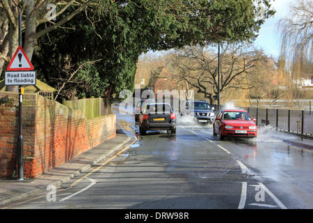 Cobham, Surrey, England, UK. 2nd February 2014. After the exceptional levels of rainfall across the UK, the River Mole has burst its banks in many places in Surrey. Here in Cobham, Mill Road is flooded with several inches of water from the adjacent river. Credit:  Julia Gavin/Alamy Live News Stock Photo