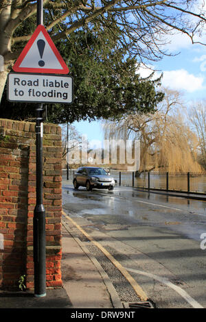 Cobham, Surrey, England, UK. 2nd February 2014. After the exceptional levels of rainfall across the UK, the River Mole has burst its banks in many places in Surrey. Here in Cobham, Mill Road is flooded with several inches of water from the adjacent river. Credit:  Julia Gavin/Alamy Live News Stock Photo