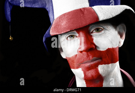 A football fan with their face painted with the English flag. Stock Photo