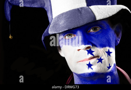 A football fan with their face painted with the Honduran flag. Stock Photo