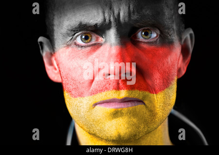 Aggresive football fan with their face painted with the German flag. Stock Photo