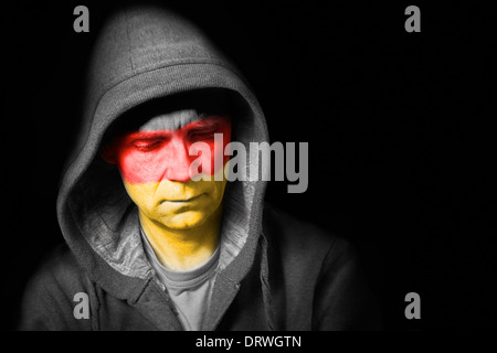 A sad expression on the face of a football fan with their face painted with the German flag. Stock Photo