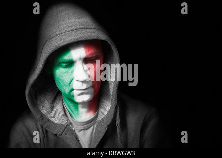 A sad expression on the face of a football fan with their face painted with the Italian flag. Stock Photo