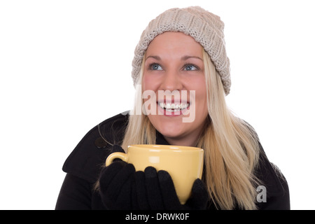 Young blond woman drinking cup of tea and looking up, isolated on a white background Stock Photo