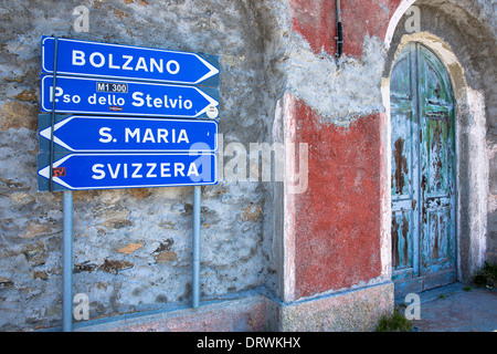 Signpost on The Stelvio Pass, Passo dello Stelvio, Stilfser Joch, in Northern Italy points to Bolzano, Santa Maria and Svizzera Stock Photo
