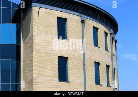 Exterior of curved modern office building with blue sky background. Stock Photo