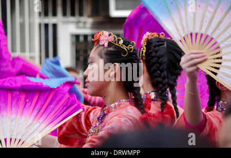 VANCOUVER, BC, CANADA, Chinatown - February 2, 2014.  Three colourfully dressed young women perform with fans as part of the Chinese New Year's Parade in Vancouver's Chinatown.   Credit: Maria Janicki/Alamy Stock Photo