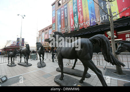 (140203) -- BEIJING, Feb. 3, 2014 (Xinhua) -- Photo taken on Feb. 2, 2014 shows horse sculptures in front of a shopping mall on Wangfujing Street, a commercial area in Beijing, capital of China. The Lunar New Year, or Spring Festival, begins on Jan. 31 and marks the start of the Year of the Horse, according to the Chinese zodiac. (Xinhua)(wjq) Stock Photo