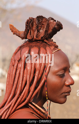 Profile of beautiful Himba woman with the traditional ochre and mud,decorated, ,and braided hairstyle of the Himba tribe,Namibia Stock Photo