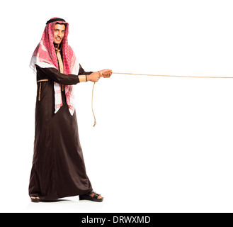 Young Arab pulling a rope isolated on white background Stock Photo