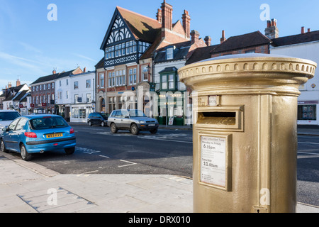 Gold painted pillar box marking the success of Team GB rowing, Henley-on-Thames, Oxfordshire, England, GB, UK. Stock Photo