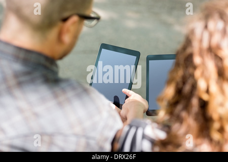 University Students Using Digital Tablets Stock Photo
