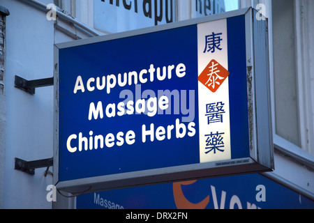 Sign above a shop showing Acupuncture Massage and Chinese Herbs Stock Photo