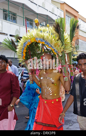 A devotee of Lord Muruga carrying a decorative cavadee during the Thaipoosam Cavadee religious festival, Mauritius. Stock Photo