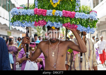 A devotee of Lord Muruga carrying a decorative cavadee during the Thaipoosam Cavadee religious festival, Mauritius. Stock Photo