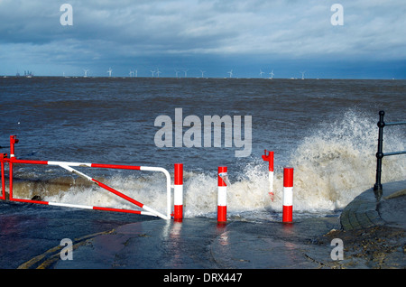 Waves breaking on slip road leading down to beach on Hoylake Promenade in the Wirral North West England Stock Photo