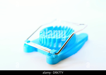 Blue egg cutter on white background Stock Photo