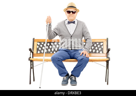 Blind senior man seated on bench Stock Photo