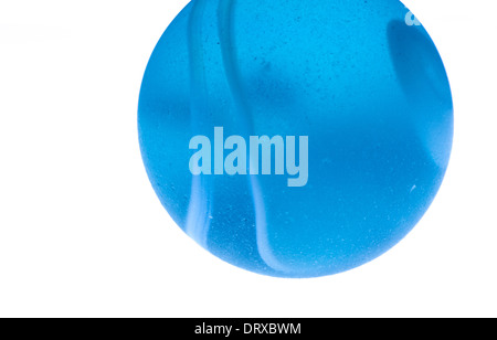 Macro, close up image of blue marble with white stripes on white backround Stock Photo