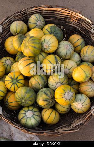 Fresh Melons for sale in a basket at an Indian market. Andhra Pradesh, India Stock Photo
