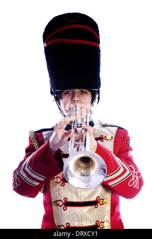 little girl playing trumpet on a gray background Stock Photo