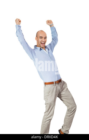 Businessman raising his fists in the air on blur office building ...