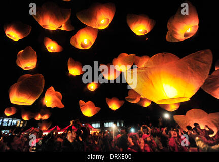 Xinbei, China's Taiwan. 3rd Feb, 2014. People release sky lanterns in Xinbei City, southeast China's Taiwan, Feb. 3, 2014. People released 600 sky lanterns at the Pingsi International Sky Lantern Festival to celebrate the Chinese lunar New Year on Monday. Credit:  Wu Ching-teng/Xinhua/Alamy Live News Stock Photo