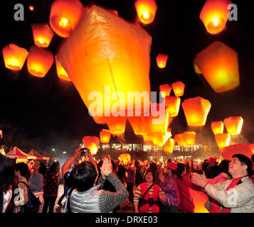 Xinbei, China's Taiwan. 3rd Feb, 2014. People release sky lanterns in Xinbei City, southeast China's Taiwan, Feb. 3, 2014. People released 600 sky lanterns at the Pingsi International Sky Lantern Festival to celebrate the Chinese lunar New Year on Monday. Credit:  Wu Ching-teng/Xinhua/Alamy Live News Stock Photo