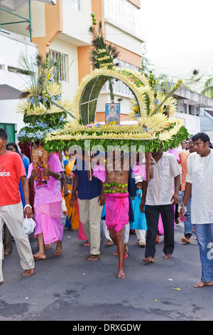 A devotee of Lord Muruga carrying a decorative cavadee during the Thaipoosam Cavadee religious festival, Mauritius. Stock Photo