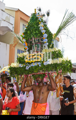 A devotee of Lord Muruga carrying a decorative cavadee during the Thaipoosam Cavadee religious festival, Mauritius. Stock Photo