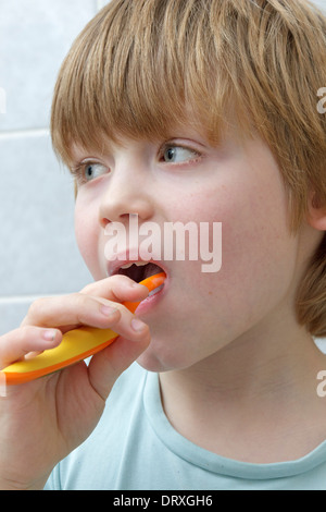 portrait of a young boy brushing his teeth Stock Photo