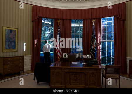 US President Barack Obama looks out the window of the Oval Office of the White House September 17, 2013 in Washington, DC. Stock Photo