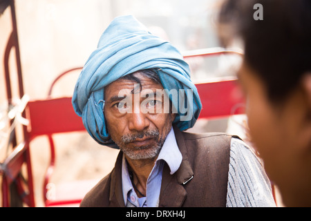 Muslim cycle rickshaw driver in Old Delhi, India Stock Photo