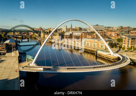 Millennium Bridge and Tyne Bridge spanning the river Tyne to join Gateshead and Newcastle, UK.