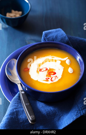 pumpkin soup in blue bowl Stock Photo