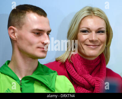 Frankfurt Main, Germany. 04th Feb, 2014. German alpine ski racer Maria Hoefl-Riesch smiles next to short-track speed-skater Robert Seifert before their departure to Sochi at Frankfurt Airport in Frankfurt Main, Germany, 04 February 2014. About 50 athletes, their coaches and assistants will fly to the Russian Black Sea coast. 153 German athletes will compete in the 2014 Winter Olympics in Sochi. Photo: ARNE DEDERT/DPA/Alamy Live News Stock Photo