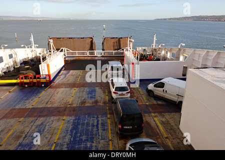 cars vans and freight trucks loaded onto a freight passenger ferry in belfast lough Stock Photo