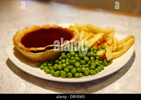 Pie and chips with peas. A traditional British Bar Dish ...