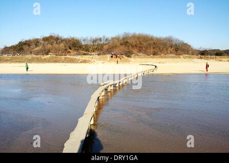 (140204) -- YEONGJU, Feb. 4, 2014 (Xinhua) -- A bridge is seen at Naeseongcheon Village in Yeongju Feb. 4, 2014. Water surrounds three sides of the villages, making the village look like an island. The village has silvery-white sand beach along the river and low hills with many pine and spindle trees surrounding the river from the other side. There is a stable bridge across the river to connect the village to the neighboring village. (Xinhua/Peng Qian) (lmz) Stock Photo