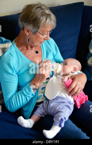 grandmother feeding baby Stock Photo