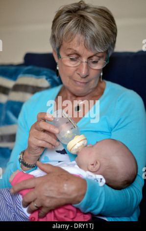 grandmother feeding grandchild Stock Photo