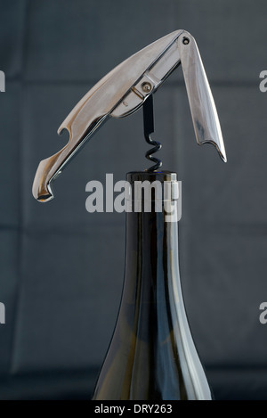 Opening a wine bottle and a dark background Stock Photo